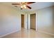 Neutral-toned bedroom featuring tile flooring and a ceiling fan for added comfort at 3262 Montclair Cir, North Port, FL 34287