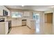 Bright kitchen with stainless steel appliances, white cabinets, and a sliding door to the patio at 3262 Montclair Cir, North Port, FL 34287
