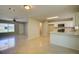 Open layout showcasing the kitchen with white cabinets and stainless steel appliances at 3262 Montclair Cir, North Port, FL 34287