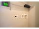 Functional laundry area with utility connections and a wire rack for storage at 3262 Montclair Cir, North Port, FL 34287