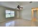 Bright living room features tile flooring and a ceiling fan at 3262 Montclair Cir, North Port, FL 34287