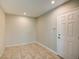 Empty room with neutral walls, tile floors and a white door at 3262 Montclair Cir, North Port, FL 34287