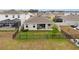 Aerial view of a backyard with fencing, grass, and a patio on a sunny day at 33581 Elm Hill Br, Wesley Chapel, FL 33545