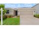 The exterior of this well-maintained home features a two-car garage and tasteful landscaping to enhance its curb appeal at 33581 Elm Hill Br, Wesley Chapel, FL 33545
