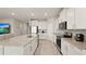 Bright, modern kitchen features granite counters, stainless steel appliances, and a functional island, perfect for cooking at 33581 Elm Hill Br, Wesley Chapel, FL 33545