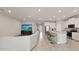 This open-concept living space seamlessly integrates the living room, kitchen, and dining area, promoting a connected lifestyle at 33581 Elm Hill Br, Wesley Chapel, FL 33545
