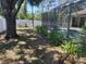 Secluded backyard with screened-in pool area, mature landscaping, and white privacy fence at 3586 Culpepper Ter, North Port, FL 34286