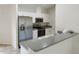 Bright kitchen with white cabinets, stainless steel appliances, and gray countertops, ready for cooking at 3586 Culpepper Ter, North Port, FL 34286