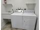 Laundry room with washer, dryer, sink, and shelving at 3586 Culpepper Ter, North Port, FL 34286