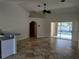 Spacious living area with tile flooring, arched doorways, and sliding glass doors leading to the pool area at 3586 Culpepper Ter, North Port, FL 34286