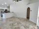 Open-concept living area with tile flooring and views to the kitchen, creating an inviting space at 3586 Culpepper Ter, North Port, FL 34286