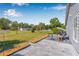An inviting stone patio with seating in a private, fenced backyard is perfect for relaxing and enjoying the outdoors at 37434 Derbyshire Dr, Zephyrhills, FL 33542