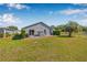The home's backyard has a patio area, lush green lawn, well-maintained landscaping, and partial fencing at 37434 Derbyshire Dr, Zephyrhills, FL 33542