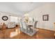 Bright dining room with hardwood floors, a chandelier, and comfortable seating at 37434 Derbyshire Dr, Zephyrhills, FL 33542