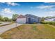 Inviting single-Gathering home showcasing a brick-faced garage, manicured lawn, and a cozy entrance at 37434 Derbyshire Dr, Zephyrhills, FL 33542