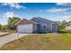 Charming single Gathering home features a brick facade, two-car garage, and well-maintained landscaping at 37434 Derbyshire Dr, Zephyrhills, FL 33542