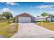 Charming single-Gathering home with a brick and siding exterior, a two-car garage, and a manicured lawn at 37434 Derbyshire Dr, Zephyrhills, FL 33542
