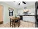 Compact kitchen area with a black ceiling fan, neutral walls, and light tile flooring at 37434 Derbyshire Dr, Zephyrhills, FL 33542