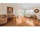 Bright living room with wood floors and lots of seating at 37434 Derbyshire Dr, Zephyrhills, FL 33542