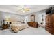 Spacious main bedroom features a ceiling fan, two windows, and an ensuite bath at 37434 Derbyshire Dr, Zephyrhills, FL 33542