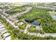 Aerial view of home in a leafy community, near a pond, backing onto a nature preserve at 4111 70Th E Ave, Ellenton, FL 34222