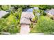 Aerial view of a lovely home with a manicured lawn and close proximity to a tranquil pond at 4111 70Th E Ave, Ellenton, FL 34222