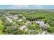 This aerial shows a quiet neighborhood, mature trees, and a private pond at 4111 70Th E Ave, Ellenton, FL 34222