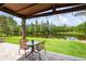 A cozy backyard patio area offers a place to relax beside a pond at 4111 70Th E Ave, Ellenton, FL 34222