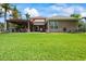 Spacious backyard featuring a covered patio with an outdoor kitchen and ample green space at 4111 70Th E Ave, Ellenton, FL 34222