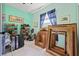 A light teal bedroom hosts a collection of large ornate gilded frames and a shelf of shoes at 4111 70Th E Ave, Ellenton, FL 34222