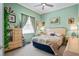 A light-filled bedroom features a cozy bed, a dresser with decor, and soft, neutral tones at 4111 70Th E Ave, Ellenton, FL 34222