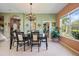 Elegant dining room with chandelier lighting and views of the lush outdoor scenery at 4111 70Th E Ave, Ellenton, FL 34222