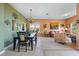 Open-concept dining and living area with stylish lighting, tile floors, and ample natural light at 4111 70Th E Ave, Ellenton, FL 34222