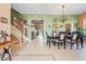 Bright and open dining area with tile floors, seamlessly connecting to the staircase and living space at 4111 70Th E Ave, Ellenton, FL 34222
