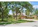 Lovely home nestled amongst lush green trees with a three car garage and beautiful paver driveway at 4111 70Th E Ave, Ellenton, FL 34222