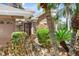 Charming front entrance with stone accents, a red door, and lush tropical landscaping at 4111 70Th E Ave, Ellenton, FL 34222
