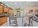Open kitchen with bar seating, stainless steel appliances, and stylish tiled backsplash at 4111 70Th E Ave, Ellenton, FL 34222