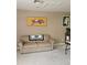 Neutral living room featuring a comfortable couch, artwork, and cozy carpeting at 4111 70Th E Ave, Ellenton, FL 34222