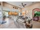 Spacious open-concept living room showcasing a view of the kitchen and high ceilings with a ceiling fan at 4111 70Th E Ave, Ellenton, FL 34222