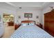 A spacious main bedroom featuring a bed with a blue pattern and a full ensuite bath at 4111 70Th E Ave, Ellenton, FL 34222