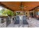 Covered outdoor kitchen featuring bar, seating, and a grill at 4111 70Th E Ave, Ellenton, FL 34222