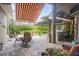 Outdoor patio with a covered seating area, built-in grill, and serene water views at 4111 70Th E Ave, Ellenton, FL 34222