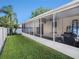 Spacious screened-in patio overlooking a lush lawn, providing an ideal outdoor living space for relaxation and entertainment at 4206 Morning Breeze Ct, Tampa, FL 33619