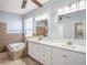 Bright bathroom featuring a double sink vanity, soaking tub, and tile surround at 4206 Morning Breeze Ct, Tampa, FL 33619