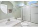 Bathroom featuring a vanity sink with brushed silver faucet, toilet, and a glass door enclosed shower at 4206 Morning Breeze Ct, Tampa, FL 33619