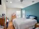 Bedroom highlighting an accent wall, and a bright window with wooden flooring at 4206 Morning Breeze Ct, Tampa, FL 33619