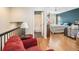 Bedroom loft area showcasing hardwood floors, an open ensuite bathroom, and a teal accent wall at 4206 Morning Breeze Ct, Tampa, FL 33619