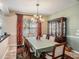 Elegant dining room boasting a stylish chandelier, wooden furniture, and tasteful decor for sophisticated dining at 4206 Morning Breeze Ct, Tampa, FL 33619