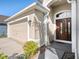Close-up showcasing the beautiful front door, garage, and well-kept landscaping, enhancing the home's curb appeal at 4206 Morning Breeze Ct, Tampa, FL 33619