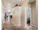 Inviting hallway with tiled floors leading to a cozy bedroom and other living areas, creating a warm ambiance at 4206 Morning Breeze Ct, Tampa, FL 33619